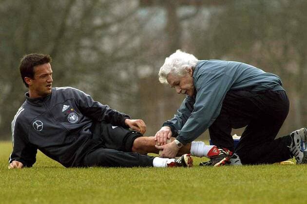 Trainingsverletzung - Fredi Bobic (li.) bekommt von Physiotherapeut Adolf Katzenmeier (beide Deutschland) einen Verband angelegt Fußball Herren Nationalmannschaftstraining 2003, Nationalmannschaft, Nationalteam, Training, Gruppe Herzogenaurach