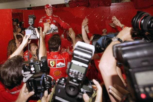 Weltmeister Michael Schumacher (Mitte, Deutschland Ferrari) lässt sich feiern und wird dabei von zahlreichen Kameras fotografiert Motorsport Grand Prix Herren Großer Preis von Japan 2003, Formel 1 Weltmeisterschaft, F1, F, GP, WM Totale Suzuka Freude, Begeisterung,