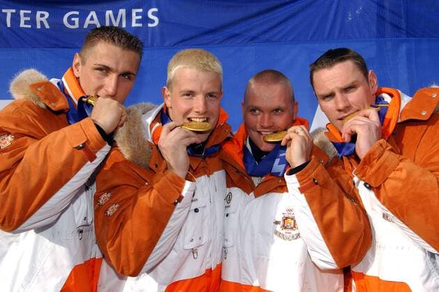 Die Crew von Deutschland 2, mit v. li.: Kevin Kuske, Pilot Andre Lange, Enrico Kühn und Carsten Embach testen den Härtegrad ihrer Goldmedaillen Bobsport OS Winter Herren Olympische Winterspiele 2002, Olympia, Olympiade, Spiele, Bob, 4er, 4 er, Vierer, Viererbob, Gruppe Salt Lake City