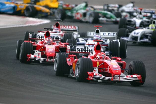 Start GP Bahrain 2004: Michael Schumacher (Deutschland Ferrari) führt das Starterfeld durch die erste Kurvenkombination Motorsport Grand Prix Herren Großer Preis von Bahrain 2004, Formel 1 Weltmeisterschaft, F1, F, GP, WM Gruppe Bahrain Racing Circuit Manama