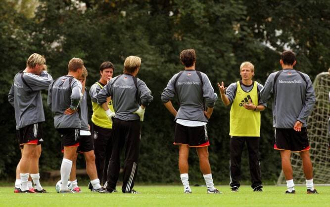 Bundestrainer Jürgen Klinsmann (2.v.re.) erläutert den Spielern eine Übung, Co-Trainer Joachim Löw (5.v.li.) hört nachdenklich zu Fußball Herren Nationalmannschaft 2004, Nationalteam, Training, Vorbereitung Gruppe Frankfurt M. Nachdenklichkeit,