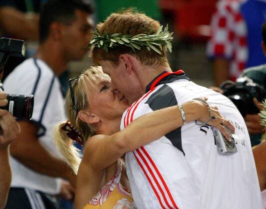Volker Zerbe (Deutschland) holt sich von seiner Frau Petra den verdienten Lohn, doch intim bleibt das Vergnügen ob des Fotografen nicht Handball OS Sommer Herren Olympische Sommerspiele Athen 2004, Olympia, Olympiade, Spiele, Finale, Endspiel, Vdig Gruppe Helliniko Romantik,