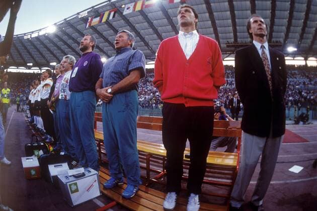 Trainerbank BR Deutschland v.re.: Teamchef Franz Beckenbauer, Assistent Holger Osieck, Mannschaftsarzt Prof. Dr. Heinrich Heß sowie die Physiotherapeut Hans Jürgen Montag und Adolf Katzenmeier singen die Nationalhymne Fußball Länderspiel Herren Weltmeisterschaft 1990, Nationalmannschaft, Nationalteam, BRD, Finale, Endspiel, Vdia Totale o0 fisheye Rom
