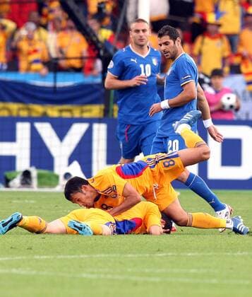 Paul Codrea fällt auf Mirel Radoi (beide Rumänien), dahinter Simone Perrotta (Italien) -  Fußball Länderspiel Herren EURO 2008, EM, Nationalteam, Nationaltrikot, Italien - Rumänien 1:1 Gruppe Zürich