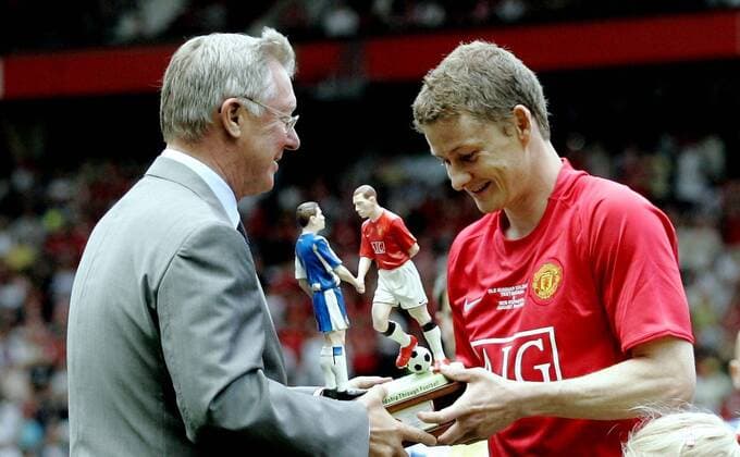Trainer Sir Alex Ferguson (li.) verabschiedet Ole Gunnar Solskjaer (beide Manchester United) mit einem Präsent -  Fußball Herren English Premier League 2008 2009, 1. Englische Liga, Ole Gunnar Solksjaers Abschiedsspiel, ManU Gruppe Manchester