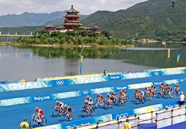 Olympia, Historie, Rückblick auf die Sommerspiele 2008 in Peking Olympischer Triathlon - Teilnehmer passieren ein typisch chinesisches Gebäude im Ming Tomb Reservoir -  Triathlon OS Sommer Olympische Spiele 2008, Sommerspiele Rad Radfahren Totale Peking