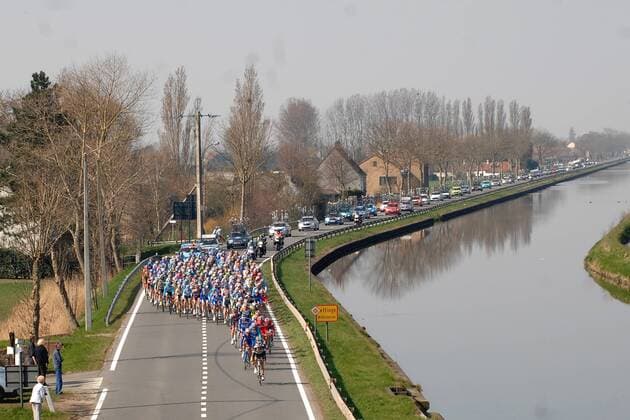 Peloton der KBC Driedaagse van De Panne Koksijde 2009 passiert auf der 1. Etappe neben einem Kanal das Ortsschild von Leffinge Radsport Herren KBC Driedaagse van De Panne Koksijde 2009, Straßenradsport, Straße, Rad, Vdig Totale 1. Etappe: Middelkerke - Zottegem
