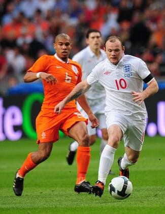 Wayne Rooney (R) of England gets past Nigel de Jong of Holland EDITORIAL USE ONLY. No use with unauthorised audio, video, data, fixture lists, club league logos or live services. Online in-match use limited to 120 images, no video emulation. No use in betting, games or single club league player publications.
