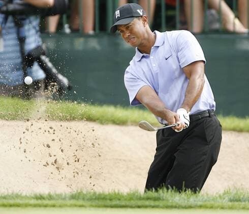 Tiger Woods (USA)blasts out of a bunker onto the 15th green during the PGA Championship  BKX2009081308 o0 Eldrick