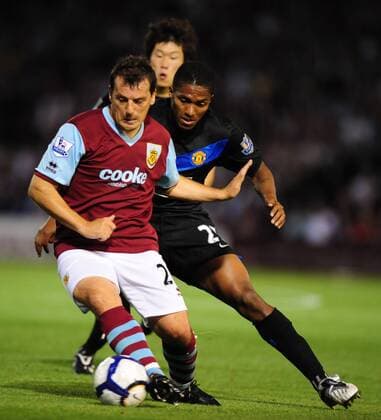 Robbie Blake (L) of Burnley hussled by Antonio Valencia (R) of Manchester United and Ji Sung Park EDITORIAL USE ONLY. No use with unauthorised audio, video, data, fixture lists, club league logos or live services. Online in-match use limited to 120 images, no video emulation. No use in betting, games or single club league player publications. o0 FC, ManU