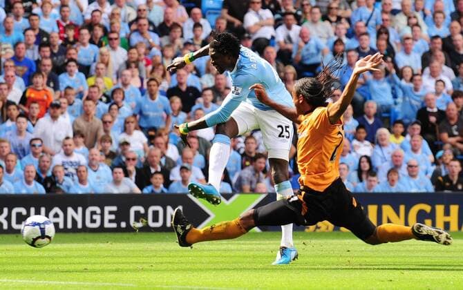 Emmanuel Adebayor (L) of Manchester City scores EDITORIAL USE ONLY. No use with unauthorised audio, video, data, fixture lists, club league logos or live services. Online in-match use limited to 120 images, no video emulation. No use in betting, games or single club league player publications.