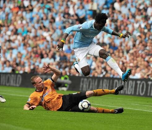 Jody Craddock (L) of Wolverhampton Wanderers tackles Emmanuel Adebayor of Manchester City EDITORIAL USE ONLY. No use with unauthorised audio, video, data, fixture lists, club league logos or live services. Online in-match use limited to 120 images, no video emulation. No use in betting, games or single club league player publications.