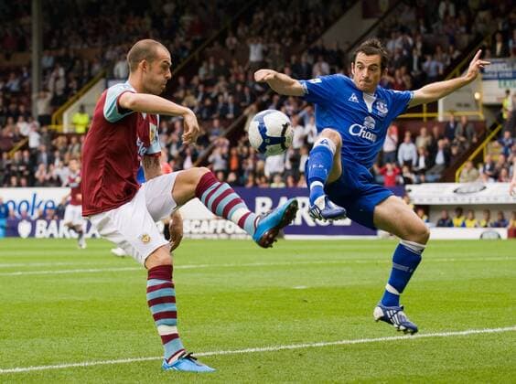 Steven Fletcher (L) of Burnley FC controls under pessue from Leighton Baines of Everton EDITORIAL USE ONLY. No use with unauthorised audio, video, data, fixture lists, club league logos or live services. Online in-match use limited to 120 images, no video emulation. No use in betting, games or single club league player publications.