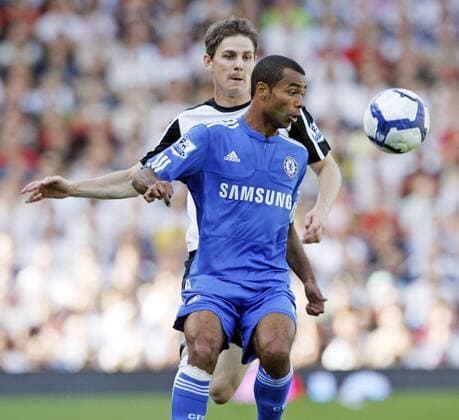 Fulham FC s Zoltan Geta tussles with Chelsea FC London s Ashley Cole (front) EDITORIAL USE ONLY. No use with unauthorised audio, video, data, fixture lists, club league logos or live services. Online in-match use limited to 120 images, no video emulation. No use in betting, games or single club league player publications.