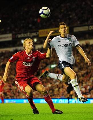 Nicky Shorey (R) of Aston Villa clears under pressure from Dirk Kuyt of Liverpool EDITORIAL USE ONLY. No use with unauthorised audio, video, data, fixture lists, club league logos or live services. Online in-match use limited to 120 images, no video emulation. No use in betting, games or single club league player publications. o0 FC