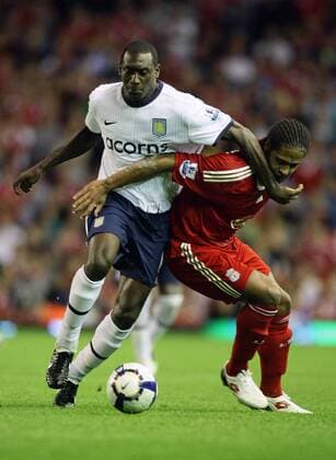 Emile Heskey (Aston Villa, L) shrugs off the challenge of Glen Johnso (Liverpool) EDITORIAL USE ONLY. No use with unauthorised audio, video, data, fixture lists, club league logos or live services. Online in-match use limited to 120 images, no video emulation. No use in betting, games or single club league player publications. o0 FC