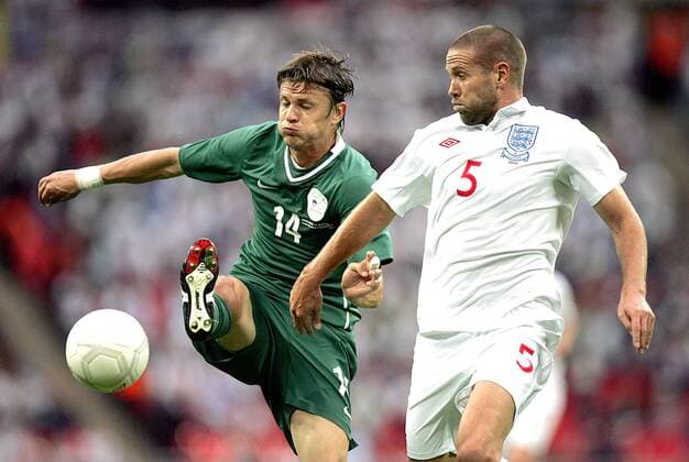 Zlatko Dedic of Slovenia (green) and Matthew Upson of England (white) fight for the ball International Friendly England (white) v Slovenia (green) 5th September, 2009 EDITORIAL USE ONLY. No use with unauthorised audio, video, data, fixture lists, club league logos or live services. Online in-match use limited to 120 images, no video emulation. No use in betting, games or single club league player publications.