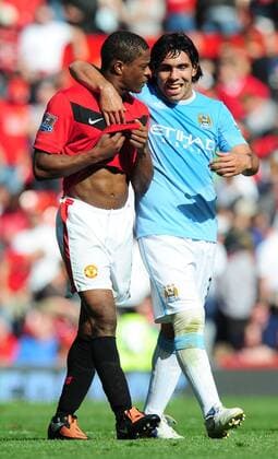 Patrice Evra (L) of Manchester United and Carlos Tevez of Manchester City walk off together - EDITORIAL USE ONLY. No use with unauthorised audio, video, data, fixture lists, club league logos or live services. Online in-match use limited to 120 images, no video emulation. No use in betting, games or single club league player publications. o0 ManU