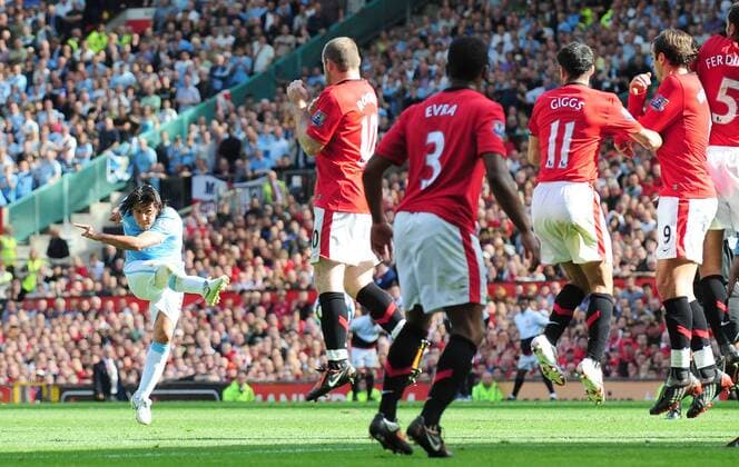 Carlos Tevez of Manchester City takes a free kick against Manchester United - EDITORIAL USE ONLY. No use with unauthorised audio, video, data, fixture lists, club league logos or live services. Online in-match use limited to 120 images, no video emulation. No use in betting, games or single club league player publications. o0 ManU