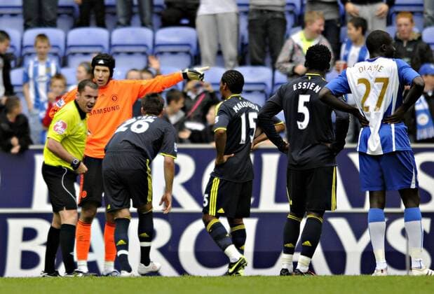 Chelsea goalkeeper Petr Cech tries to protest his innocence to referee Phil Dowd. Barclays Premier League Wigan Athletic v Chelsea 26th September, 2009 EDITORIAL USE ONLY. No use with unauthorised audio, video, data, fixture lists, club league logos or live services. Online in-match use limited to 120 images, no video emulation. No use in betting, games or single club league player publications. o0 FC