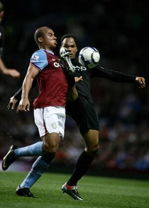 Gabriel Agbonlahor (L) of Aston Villa competes with Joleon Lescott of Manchester City - EDITORIAL USE ONLY. No use with unauthorised audio, video, data, fixture lists, club league logos or live services. Online in-match use limited to 120 images, no video emulation. No use in betting, games or single club league player publications. o0 Birmingham