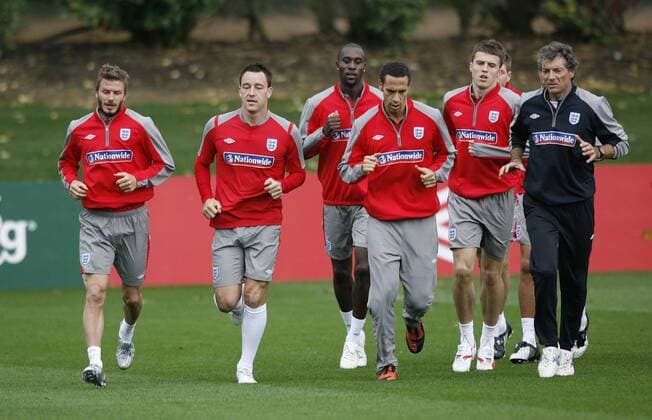 England s players warm up with David Beckham (L) and John Terry (2L ) EDITORIAL USE ONLY. No use with unauthorised audio, video, data, fixture lists, club league logos or live services. Online in-match use limited to 120 images, no video emulation. No use in betting, games or single club league player publications.