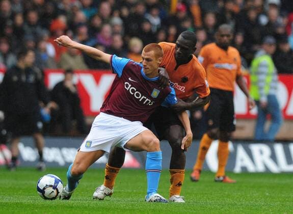 Steve Sidwell of Aston Villa (L) and Geoge Elokobi of Wolverhampton Wanderers EDITORIAL USE ONLY. No use with unauthorised audio, video, data, fixture lists, club league logos or live services. Online in-match use limited to 120 images, no video emulation. No use in betting, games or single club league player publications.