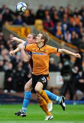 Kevin Doyle of Wolverhampton Wanderers (R) nd Richard Dunne of Aston Villa EDITORIAL USE ONLY. No use with unauthorised audio, video, data, fixture lists, club league logos or live services. Online in-match use limited to 120 images, no video emulation. No use in betting, games or single club league player publications.