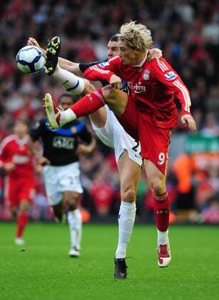 Fernando Torres of Liverpool (R) challenges with Nemanja Vidic of Manchester United EDITORIAL USE ONLY. No use with unauthorised audio, video, data, fixture lists, club league logos or live services. Online in-match use limited to 120 images, no video emulation. No use in betting, games or single club league player publications.