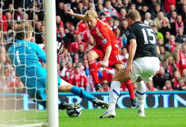 Goalkeeper Edwin van der Sar of Manchester United makes a save from Dirk Kuyt (C) of Liverpool EDITORIAL USE ONLY. No use with unauthorised audio, video, data, fixture lists, club league logos or live services. Online in-match use limited to 120 images, no video emulation. No use in betting, games or single club league player publications.