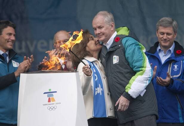 Vancouver Mayor Gregor Robertson (L,) and Canadian Prime Minister Stephen Harper (R) clap as VANOC CEO John Furlong (2.R.) hugs recent widow Darlene Poole (all Canada) after she successfully lit the 1.2-meter community celebration cauldron with the Olympic Flame at the BC Legislature where the first torch bearers of the 2010 Winter Olympic Torch Relay will start in Victoria -  VIC2009103015 o0 Funktionär, Politik, people,