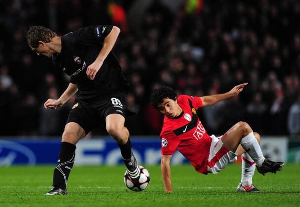 Fabio Da Silva of Manchester United (R) misses a tackle on Tomas Necid of CSKA Moscow - EDITORIAL USE ONLY. No use with unauthorised audio, video, data, fixture lists, club league logos or live services. Online in-match use limited to 120 images, no video emulation. No use in betting, games or single club league player publications.