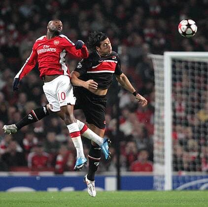 William Gallas (L) of Arsenal and Graziano Pelle of AZ Alkmaar leap for the ball - Arsenal FC London - AZ Alkmaar - EDITORIAL USE ONLY. No use with unauthorised audio, video, data, fixture lists, club league logos or live services. Online in-match use limited to 120 images, no video emulation. No use in betting, games or single club league player publications.