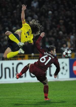 FC Barcelona s Carles Puyol (L) and Rubin Kazan s Gokdeniz Karadeniz  Premiumd TASS_1055265