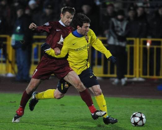 FC Barcelona s Lionel Messi (R) and Rubin Kazan s Sergei Semak  Premiumd TASS_1055267