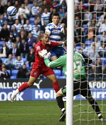 Grzegorz Rasiak (B) of Reading FC rises above Liam Rosenior of Ipswich Town to head the ball - EDITORIAL USE ONLY. No use with unauthorised audio, video, data, fixture lists, club league logos or live services. Online in-match use limited to 120 images, no video emulation. No use in betting, games or single club league player publications. Reading
