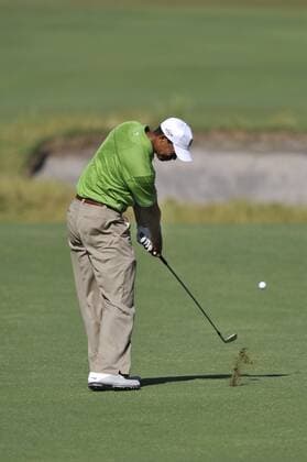 TIGER WOODS (USA) takes aim beyond the fairway bunker in the heat. - ZUMAmm5