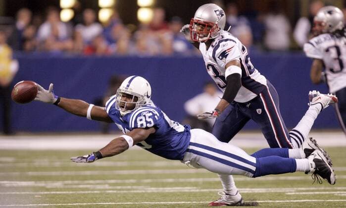 Indianapolis Colts wide receiver Pierre Garcon (85) reaches for a pass in front of New England Patriots cornerback Leigh Bodden (23) during the second quarter at Lucas Oil Field in Indianapolis on November 15, 2009  IND2009111509