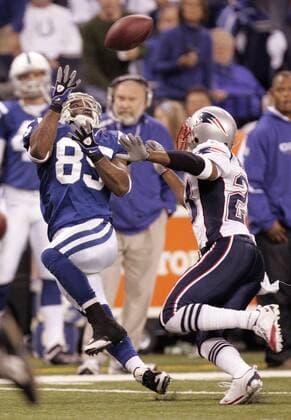 Indianapolis Colts wide receiver Pierre Garcon reaches for a pass over New England Patriots cornerback Leigh Boddon (23) during the second quarter at Lucas Oil Field in Indianapolis on November 15, 2009  IND2009111511