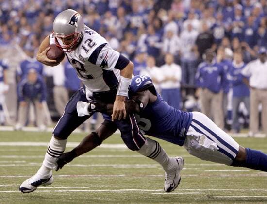 New England Patriots quarterback Tom Brady (12) is sacked by Indianapolis Colts defensive end Robert Mathis (98) during the second quarter at Lucas Oil Field in Indianapolis on November 15, 2009  IND2009111515