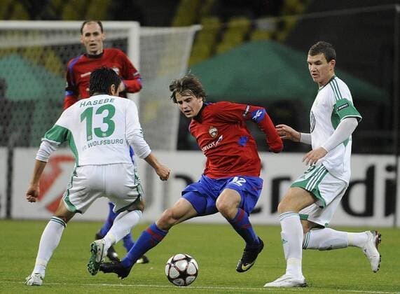 152: MOSCOW, RUSSIA. NOVEMBER 25, 2009. VfL Wolfsburg s Makoto Hasebe, Edin Dzeko (L-R white), CSKA s Georgy Shchennikov (front red) seen in the UEFA Champions League match. CSKA Moscow beat VfL Wolfsburg 2 - 1.  RE0C3190