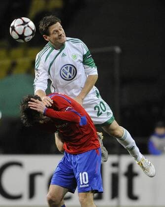 153: MOSCOW, RUSSIA. NOVEMBER 25, 2009. VfL Wolfsburg s Sascha Riether (white) and CSKA s Alan Dzagoev (red) seen in the UEFA Champions League match. CSKA Moscow beat VfL Wolfsburg 2 - 1.  RE0C3198