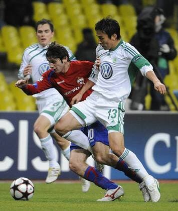 154: MOSCOW, RUSSIA. NOVEMBER 25, 2009. VfL Wolfsburg s Makoto Hasebe (R white) and CSKA s Alan Dzagoev (red) seen in the UEFA Champions League match. CSKA Moscow beat VfL Wolfsburg 2 - 1.  RE0C3194
