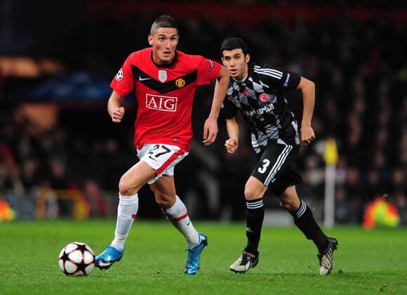 Federico Macheda (Manchester United, ManU, l.) gets past Ismail Koybasi (Besiktas Istanbul) - Manchester United v Besiktas -EDITORIAL USE ONLY. No use with unauthorised audio, video, data, fixture lists, club league logos or live services. Online in-match use limited to 120 images, no video emulation. No use in betting, games or single club league player publications.