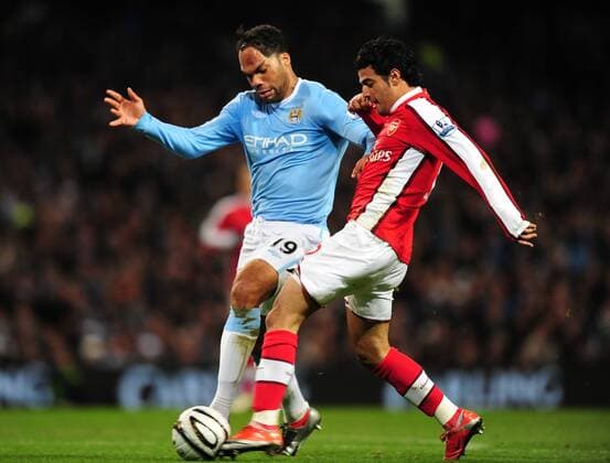 Joleon Lescott of Manchester City (L) blocks a shot from Carlos Vela of Arsenal Carling Cup Manchester City v Arsenal 2nd December, 2009 EDITORIAL USE ONLY. No use with unauthorised audio, video, data, fixture lists, club league logos or live services. Online in-match use limited to 120 images, no video emulation. No use in betting, games or single club league player publications. o0 FC