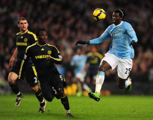 Emmanuel Adebayor of Manchester City (R) jumps to control the ball past Michael Essien of Chelsea FC London Barclays Premier League Manchester City v Chelsea FC London 5th December, 2009 EDITORIAL USE ONLY. No use with unauthorised audio, video, data, fixture lists, club league logos or live services. Online in-match use limited to 120 images, no video emulation. No use in betting, games or single club league player publications.