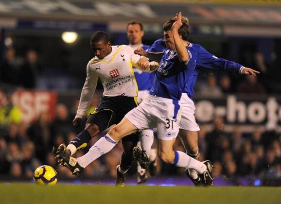Jermaine Defoe of Tottenham (L) taes a shot on goal as Seamus Coleman of Everton dives in to block Barclays Premier League Everton FC v Tottenham Hotspur 6th December, 2009 EDITORIAL USE ONLY. No use with unauthorised audio, video, data, fixture lists, club league logos or live services. Online in-match use limited to 120 images, no video emulation. No use in betting, games or single club league player publications.
