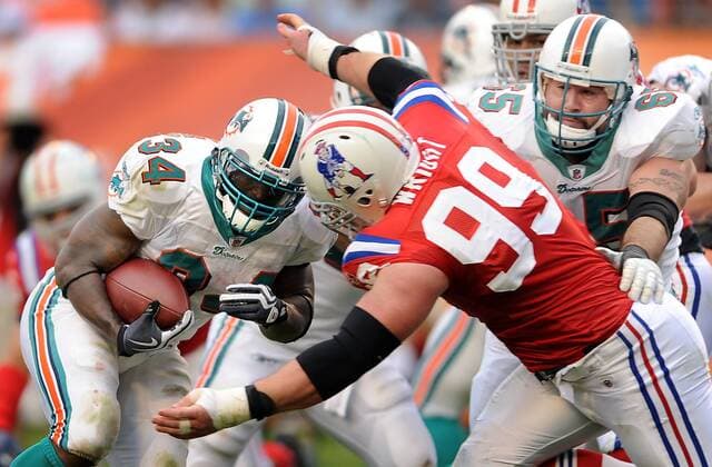Dec. 06, 2009 - miami, Florida, USA - Miami ---finsrd06s---Miami Dolphins host the New England Patriots at Land Shark Stadium. Miami s Ricky Williams runs the ball deep in Patriot territory as defensive lineman Mike Wright comes on defense. - ZUMAss5