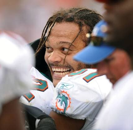 Dec. 06, 2009 - miami, Florida, USA - Miami Gardens---finsrd06d---Miami Dolphins host the New England Patriots at Land Shark Stadium. Miami linebacker Channing Crowder is all smiles on the team bench after officials declared his fourth quarter interception a good play, sealing the Dolphins victory. - ZUMAss5