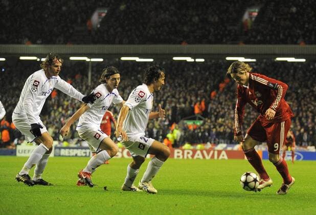 Three Fiorentina players line up to defend against Fernando Torres of Liverpool (R) - FC Liverpool - ACF Fiorentina; AC Florenz - EDITORIAL USE ONLY. No use with unauthorised audio, video, data, fixture lists, club league logos or live services. Online in-match use limited to 120 images, no video emulation. No use in betting, games or single club league player publications.
